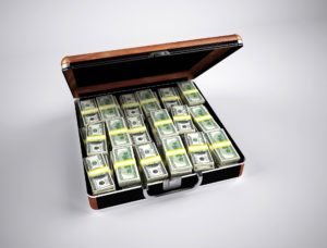 Half-open briefcase filled with wads of dollar bills