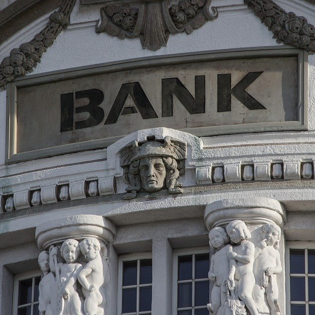 Bank facade with baroque gargoyles and cherubs on the outer columns